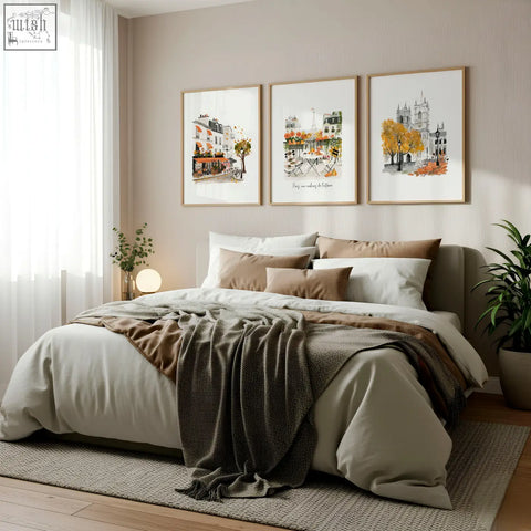 A cozy bed with beige and brown linens and a gray throw in front of parisian autumn bedroom wall pictures set of 3
