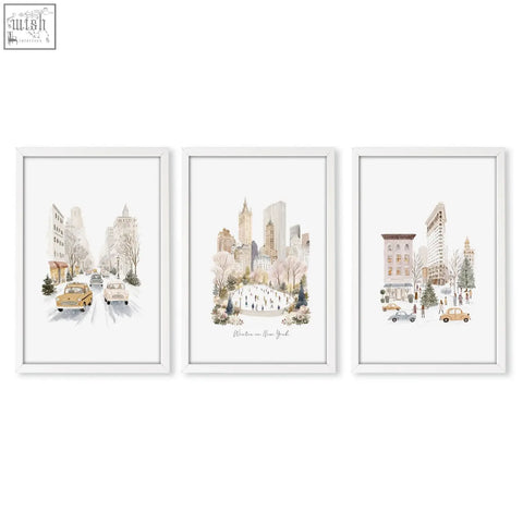 Set of three white-framed bedroom wall prints featuring snowy new york city winter scenes in watercolor style