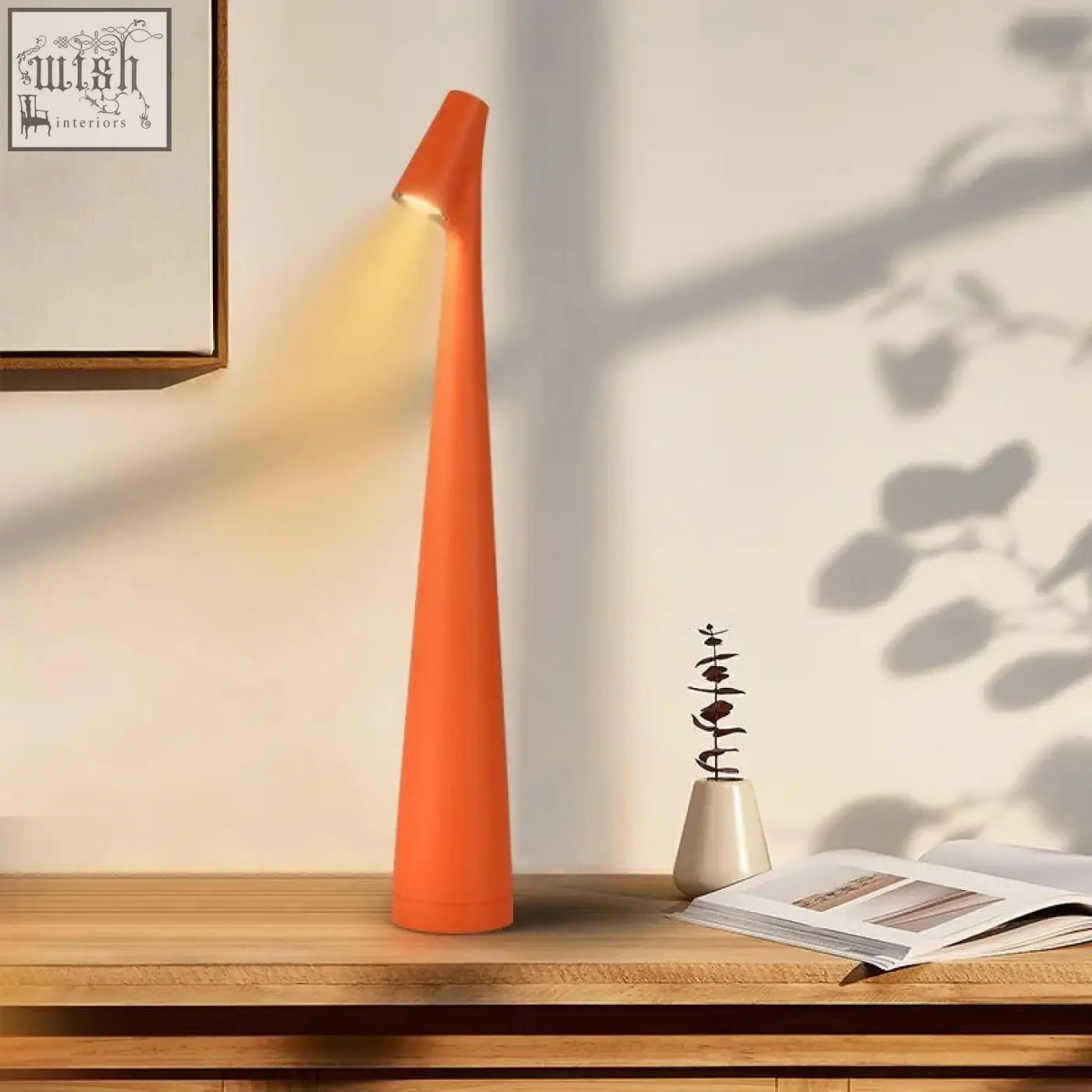 Orange tapered table lamp with warm light perfect for living rooms and minimal space bedrooms