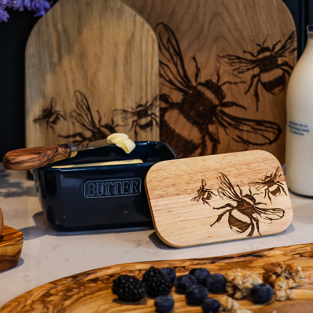 Dark blue ceramic butter dish with a wooden lid engraved with bee designs perfect as a blue butter dish