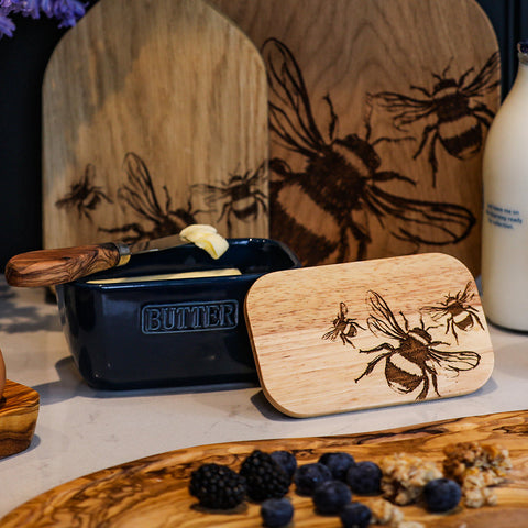 Dark blue ceramic butter dish with a wooden lid engraved with bee designs perfect as a blue butter dish