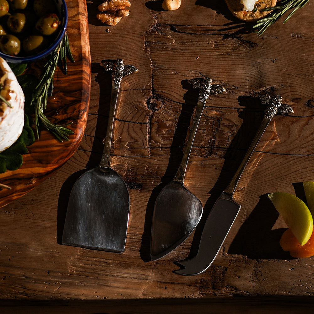 Set of three metallic bee cheese knives with matte finish and unique blades perfect for cheese board gift box sets