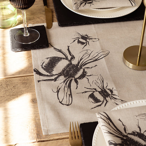 Beige linen table runner with bold black ink bee illustration perfect for a stylish linen table setup
