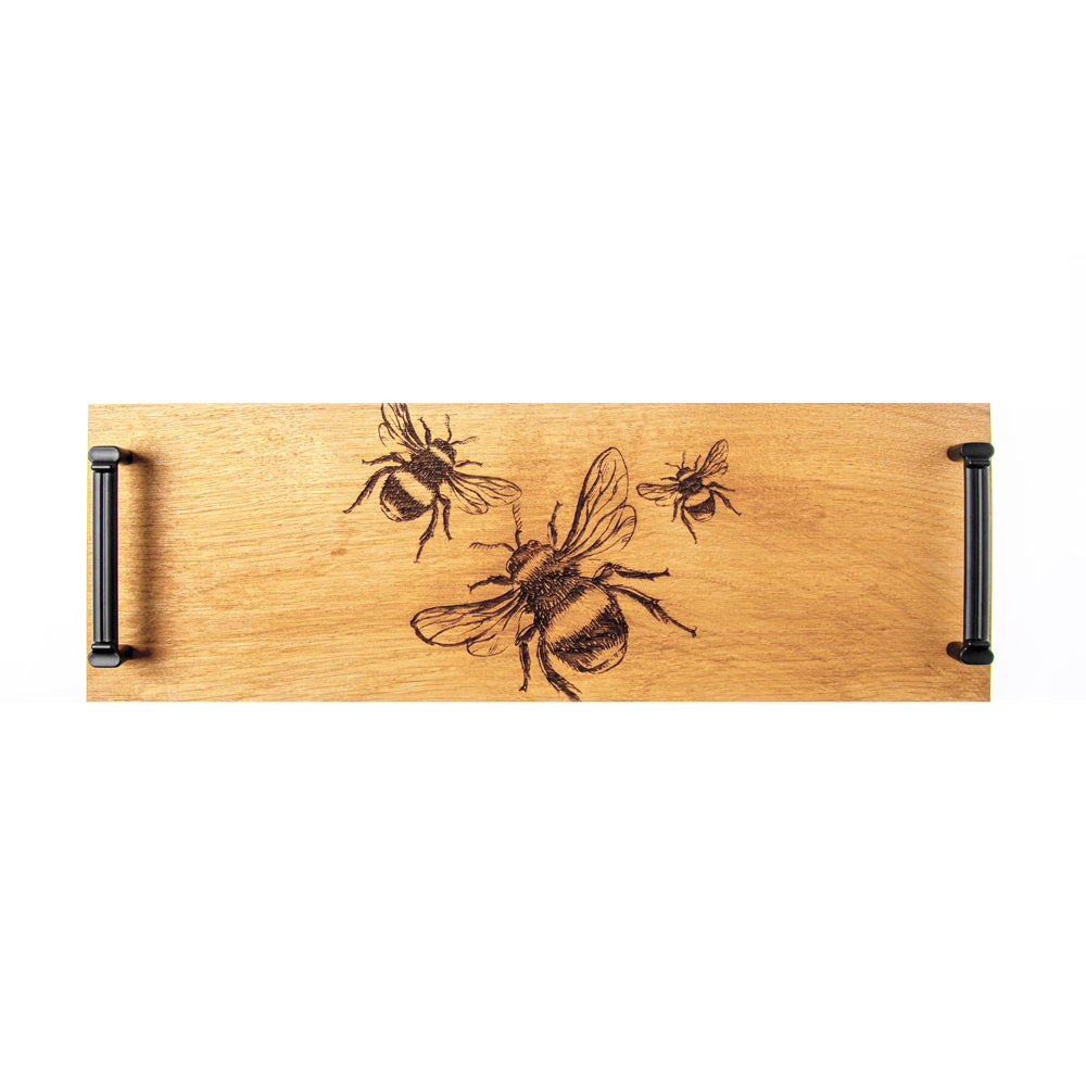 Light british oak serving tray with black engraved bee designs and matching black metal handles