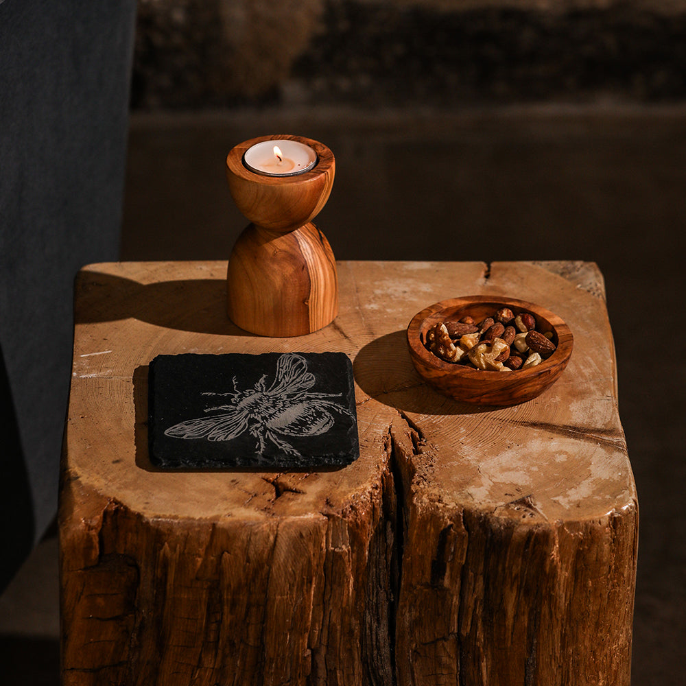 Rustic olive wood candle holder with polished finish and natural grain paired with single slate coaster