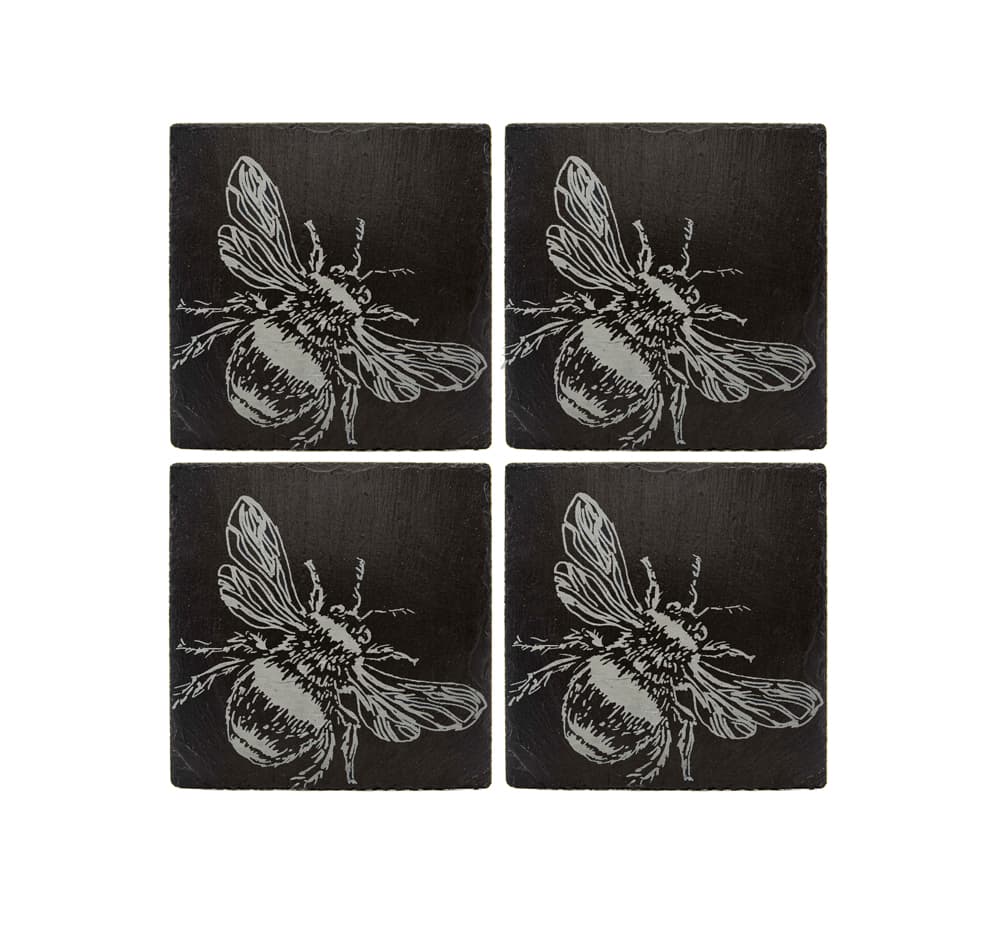 Set includes four black slate coasters with detailed white bee etchings in bee slate placemat gift set