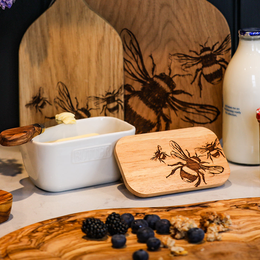 White bee ceramic butter dish with wooden handle and engraved bee design lid for stylish kitchen use