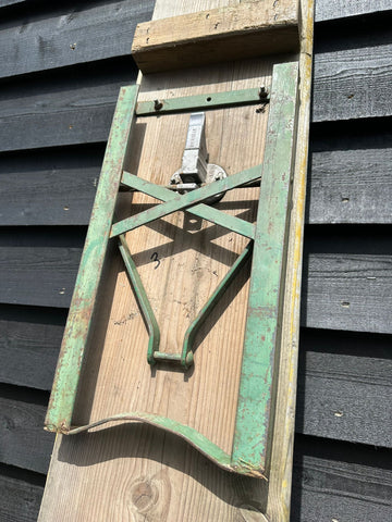 Vintage green wooden sled with metal braces and latch perfect for beer festival picnic bench or garden seating