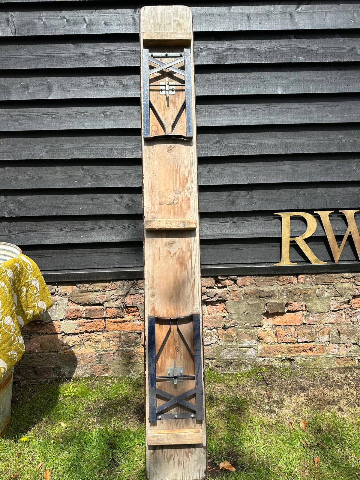 A rustic wooden gate with metal cross-bracing and latch as a perfect beer festival garden furniture accessory