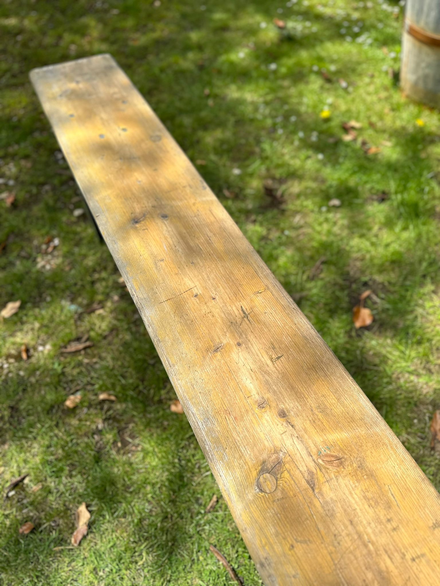 Weathered wooden beer festival fold up bench with light brown finish and visible grain perfect for garden seating