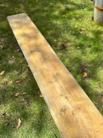 Weathered wooden beer festival fold up bench with light brown finish and visible grain perfect for garden seating