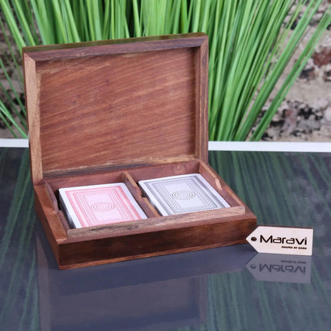 Wooden card box begunia with warm brown finish holding red and blue backed playing cards in divided compartments