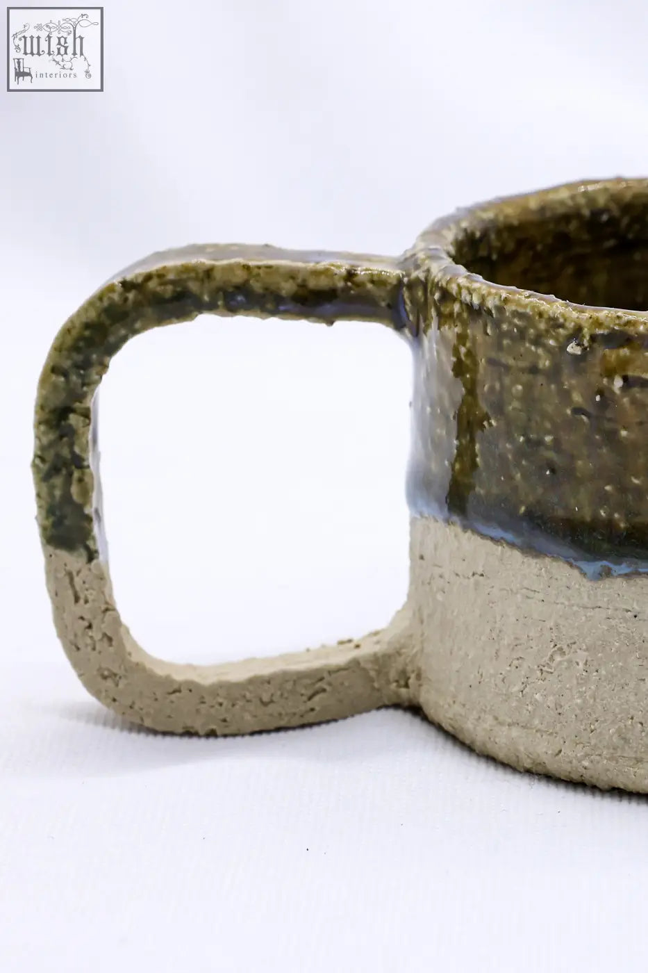 Beige grande handmade milled big ceramic mug with textured earthy green glaze and contrasting beige stoneware base