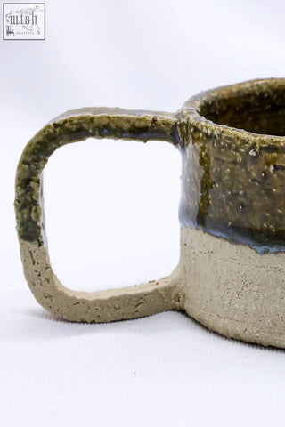 Beige grande handmade milled big ceramic mug with textured earthy green glaze and contrasting beige stoneware base