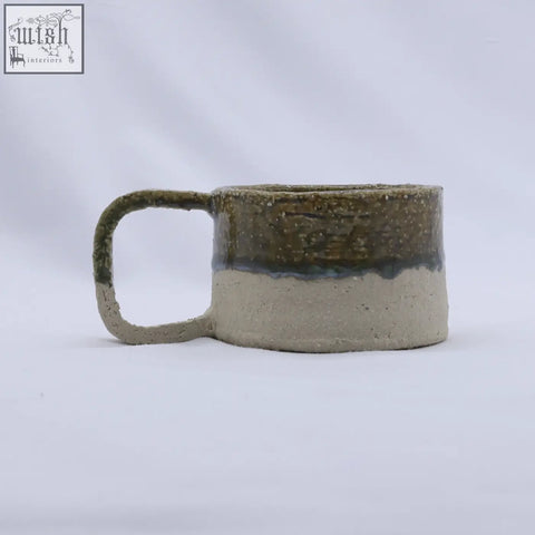 Beige grande handmade milled stoneware mug with speckled olive green glaze and matte beige base with loop handle