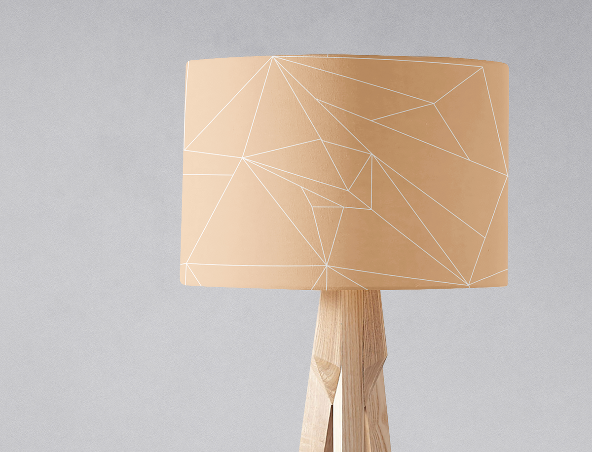 Beige minimalist lampshade with white geometric lines on a light wood tripod base table lamp shade