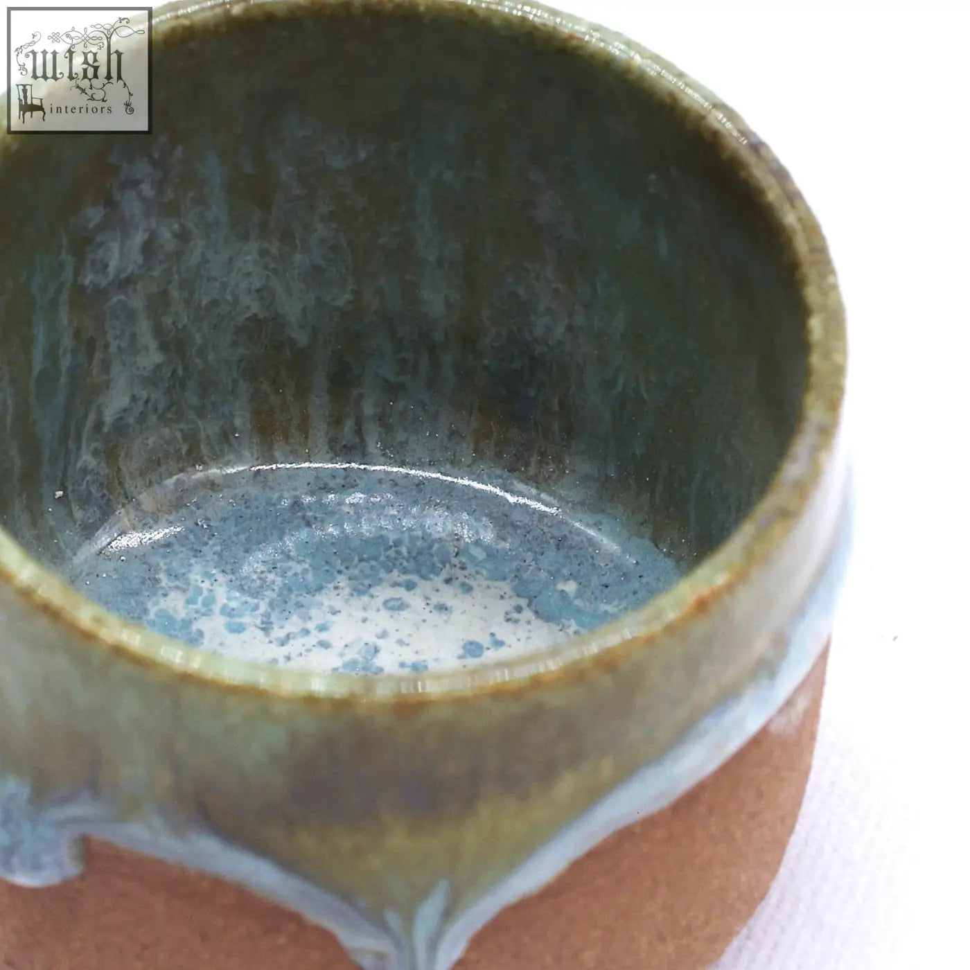 Beige picollo handmade ceramic espresso mug with rustic earthy finish and mottled green brown glaze drips down sides