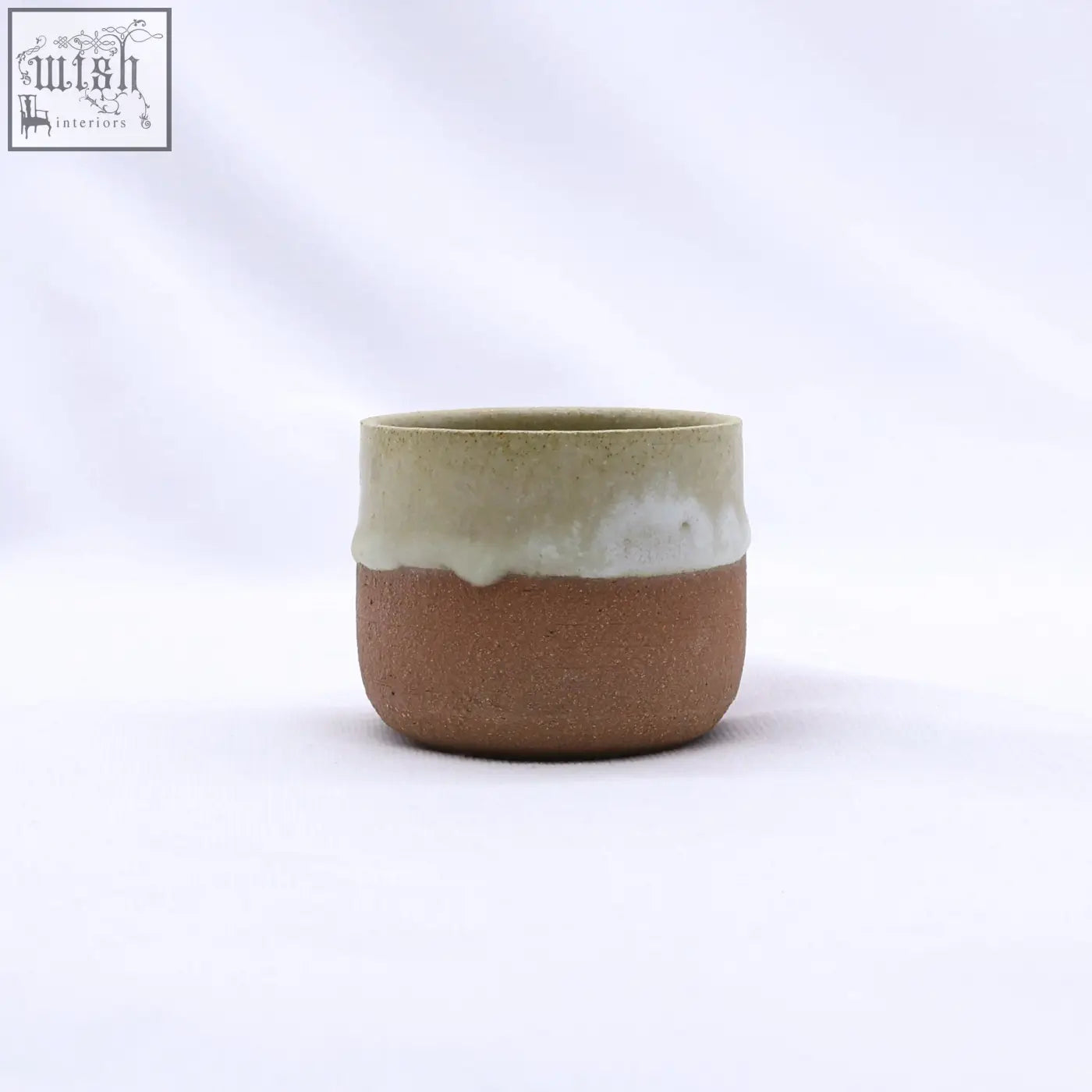 Beige picollo handmade ceramic terra stoneware espresso mug with rustic brown body and glazed greenish white rim