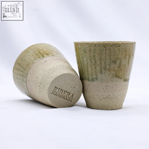 Two handmade beige quadra milled stoneware tall ceramic cups with textured earthy green and beige glaze finish
