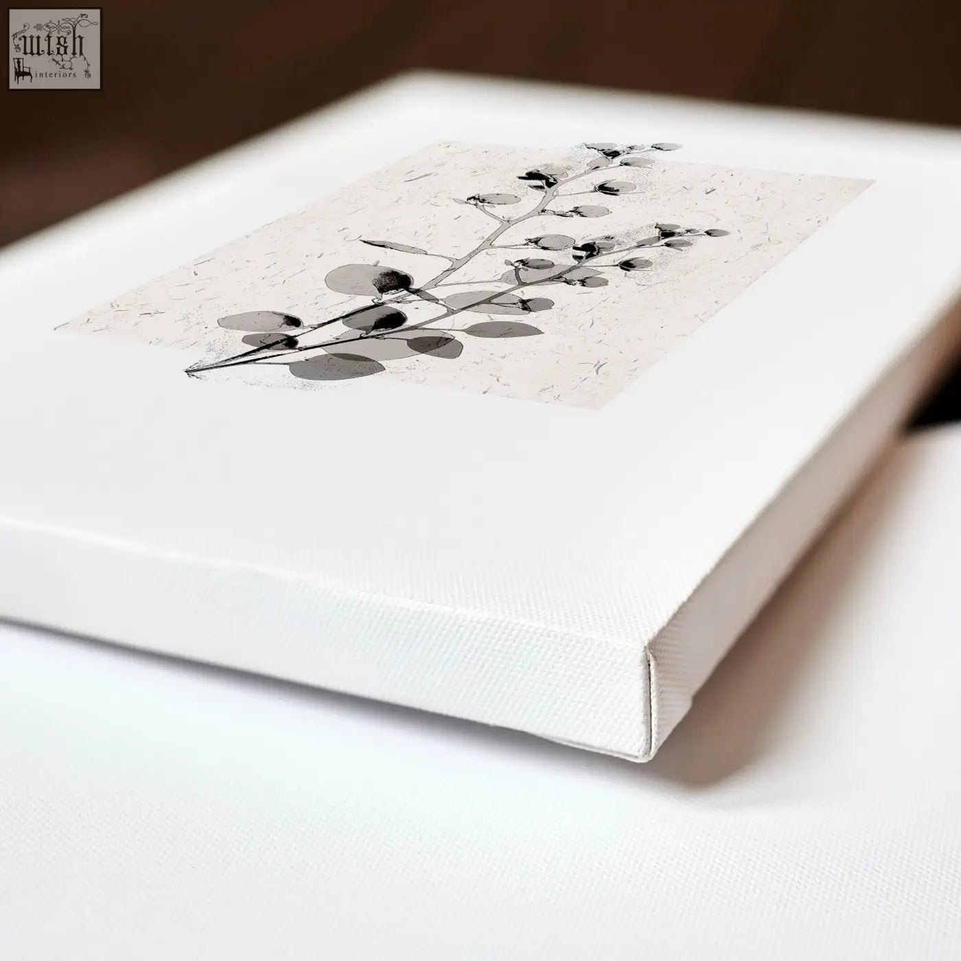 White canvas wall art with minimalist black and gray eucalyptus illustration on textured paper for beige wall decor