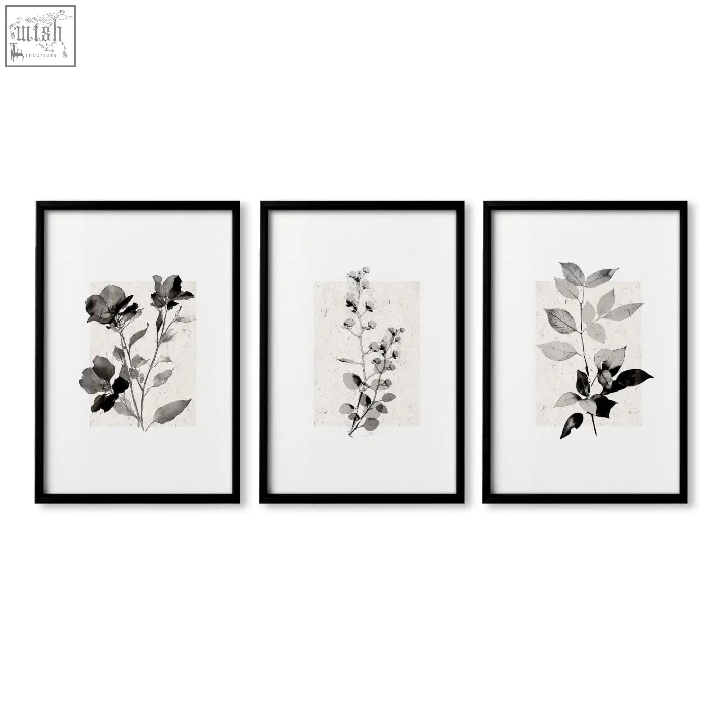 Set of three black-framed beige wall art prints with monochrome botanical pressed flower and leaf designs on textured paper