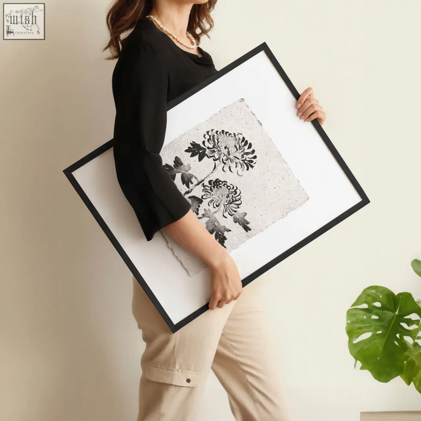 Black-framed beige wall art featuring delicate black and white floral prints on textured off-white paper set of 3