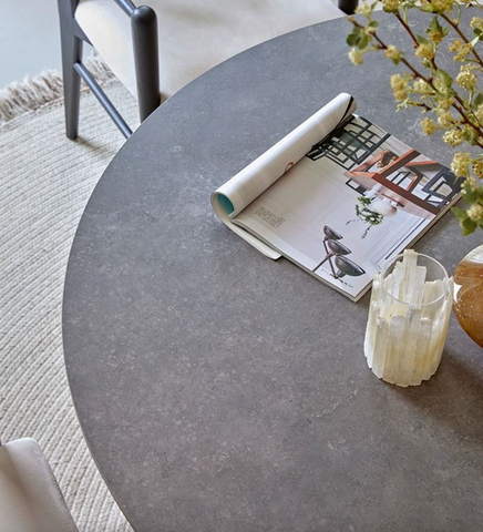 Brown bek round dining table with gray stone textured matte finish perfect for round dining spaces