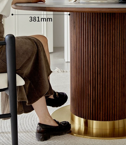 Bek round dining table in brown with a dark wood ribbed pedestal base and polished brass foot perfect for round dining