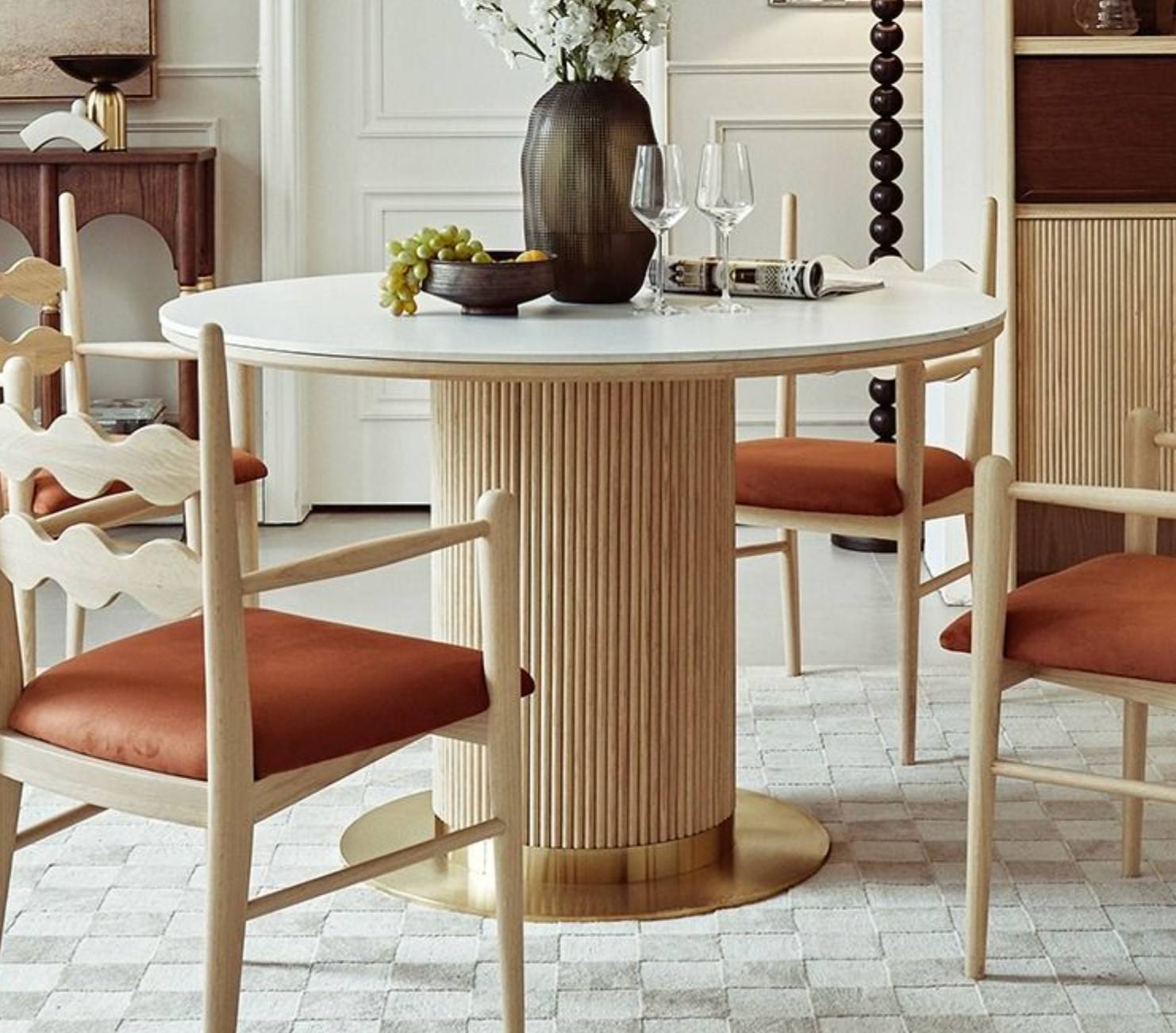 Bek round dining table with white marble top and ribbed light wood base finished in gold for elegant round dining
