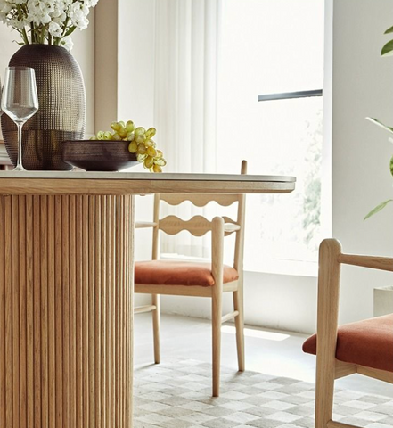 Bek round dining table features a modern round dining design with a light wood ribbed base and concrete top