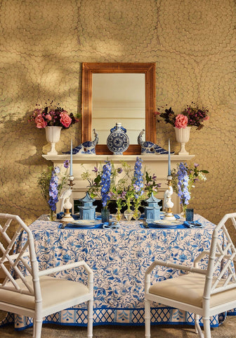 Belgravia Bloom blue cotton tablecloth with a delicate blue and white floral pattern draped over a dining table