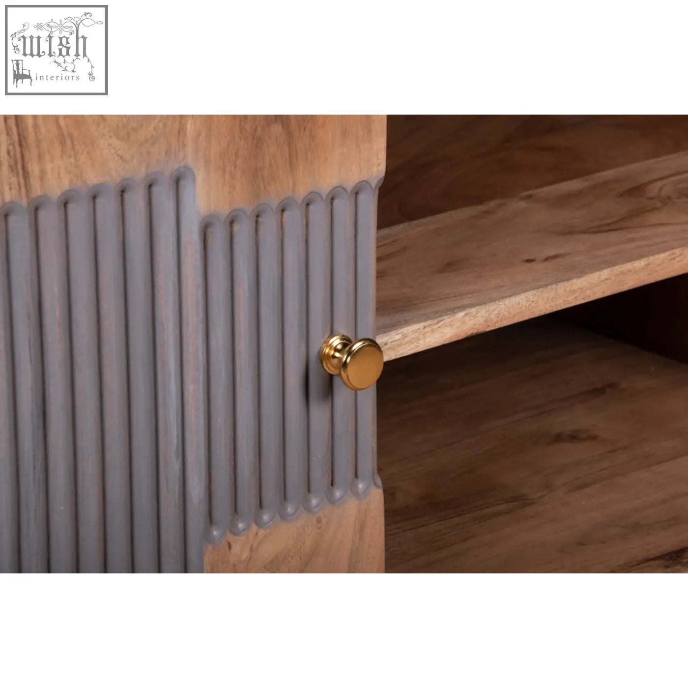 Gray ribbed cabinet door with gold knob on berkley acacia wood tv unit featuring lower storage compartments