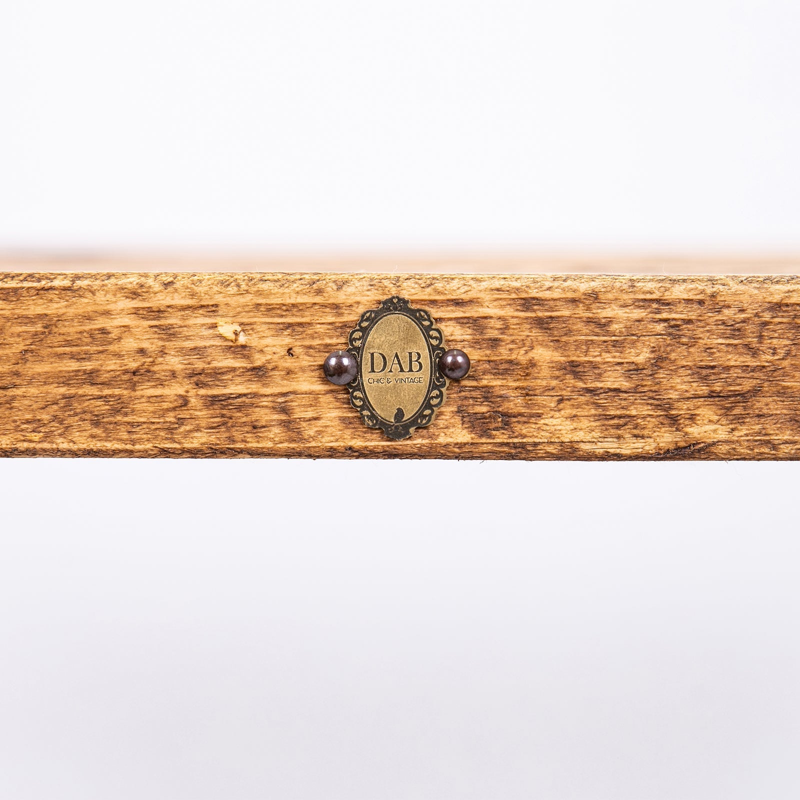 A rustic wooden tray with a vintage dab emblem on a bespoke solid wooden bench with industrial steel hairpin legs