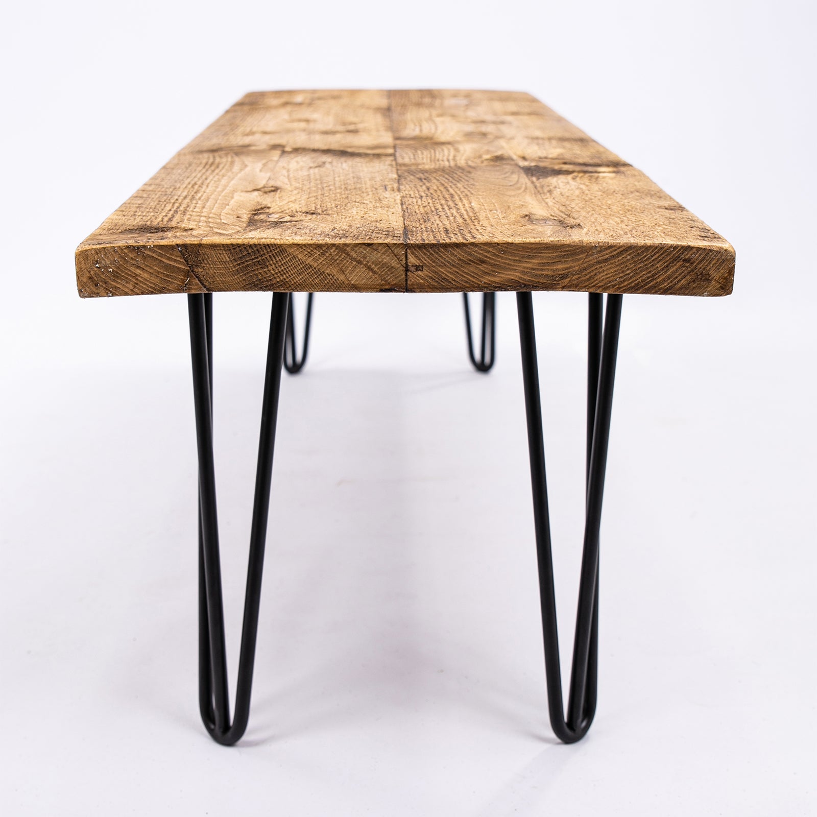 Rustic solid wooden bench with industrial steel hairpin legs on a wooden table with free uk delivery and furniture care