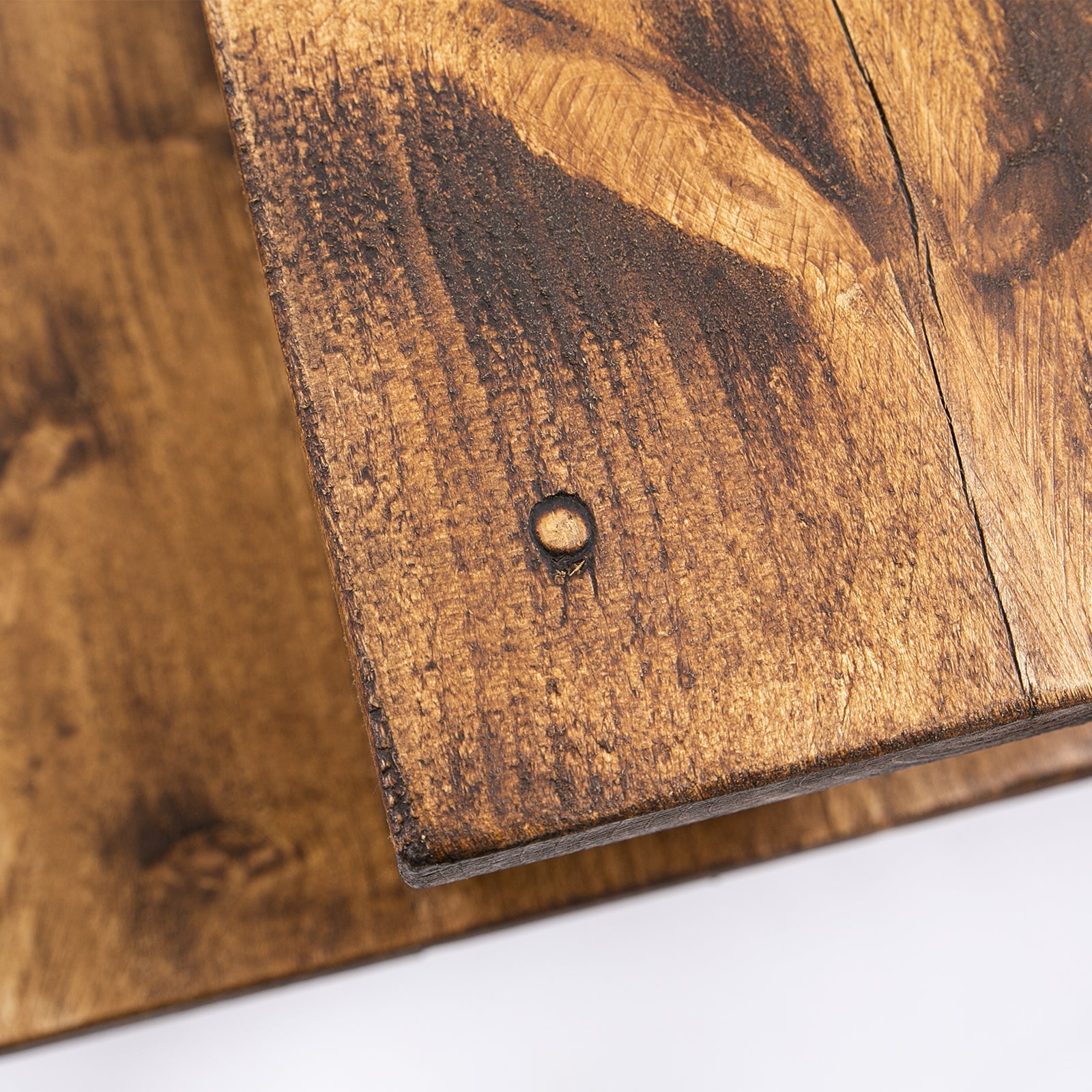 Rustic dark brown wooden plank with grain and hole for bespoke work from home desk furniture care kit use
