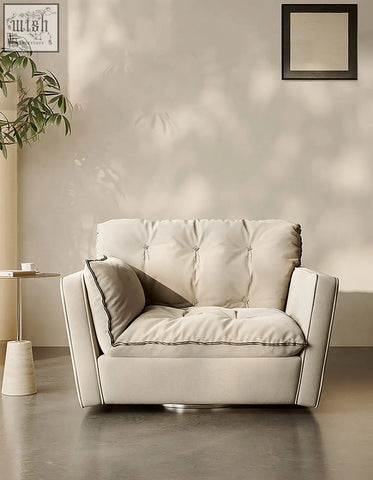 Cream-colored beige bhatia swivel snuggle chair with tufted upholstery and sleek modern design for cozy seating