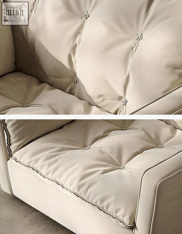 Cream-colored leather swivel snuggle chair with tufted button details and clean modern lines in beige