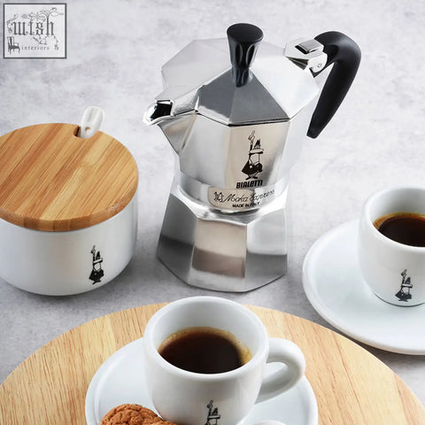 Silver octagonal bialetti moka express coffee maker with black handle and knob for rich espresso brewing