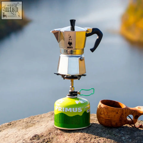 Stainless steel bialetti moka express with black handle and spout featuring classic italian moka pot design