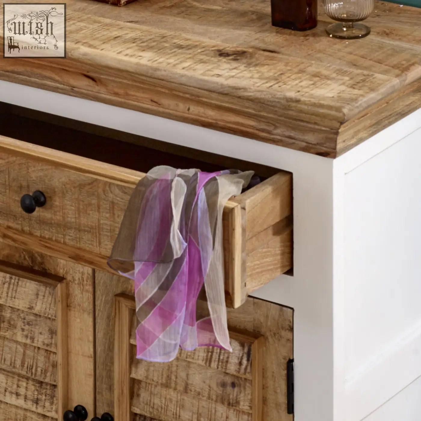 A sheer striped purple and gray scarf hangs from the edge of a solid mango wood bianco small sideboard drawer