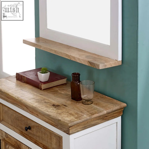 Rustic wooden shelf with natural grain and knots mounted above a white solid mango wood sideboard cabinet