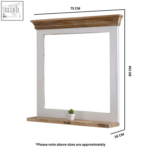 White framed bianco solid mango wood wall mirror with natural wood crown and base featuring a potted succulent