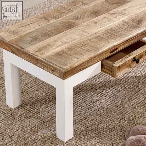 Rustic mango wood coffee table with white painted legs and black handle drawer for living room use