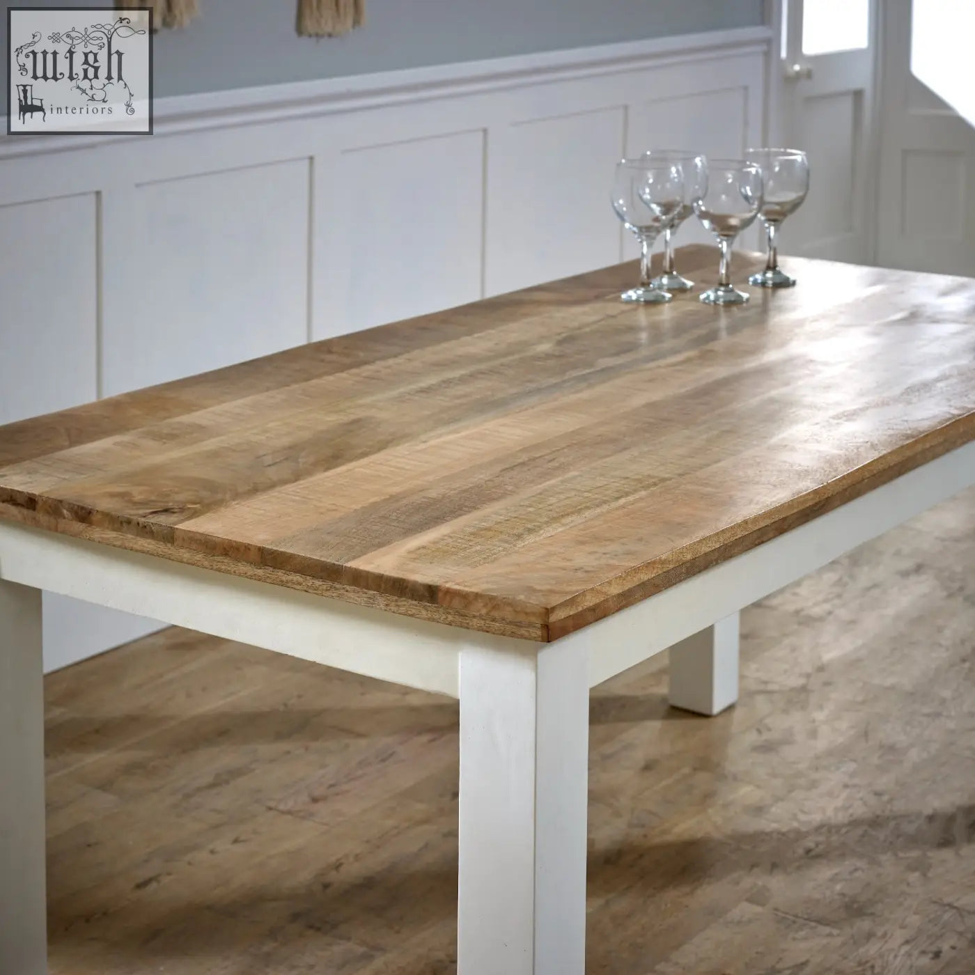 Bianco solid mango wood dining table with a rustic light brown top and white legs perfect for cozy meals