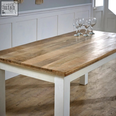 Bianco solid mango wood dining table with a rustic light brown top and white legs perfect for cozy meals