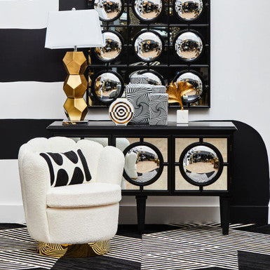 Cream-colored white boucle scalloped swivel chair with black geometric patterns and gold-tone legs by biarritz
