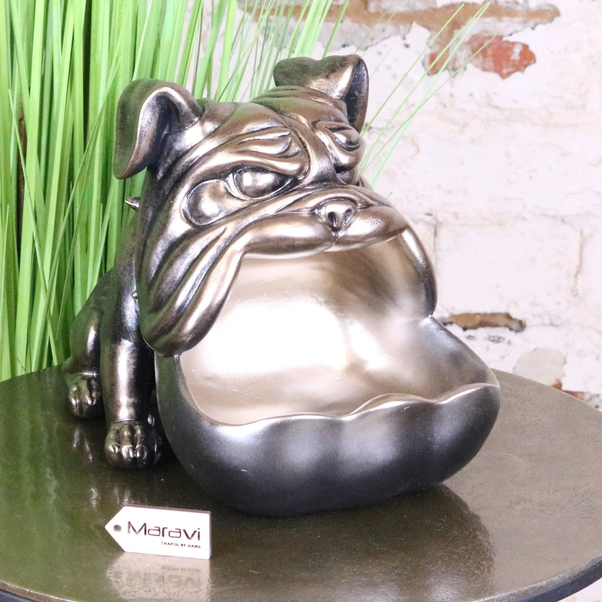 A sleek metallic big gob dog novelty bowl with glossy silver bulldog figurine on a reflective surface