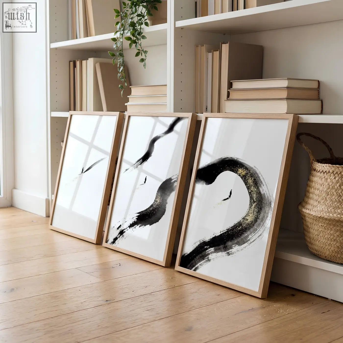 Three minimalist living room wall art pieces with bold black ink brushstrokes in light wood frames white background