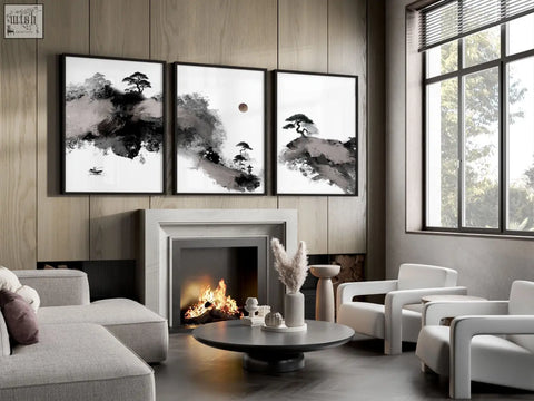 Three framed black and white japanese ink landscape art prints hang above the fireplace as big painting for living room