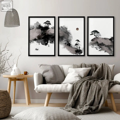 Three framed black-and-white japanese ink landscape art prints hang above a white sofa in a living room big painting setup
